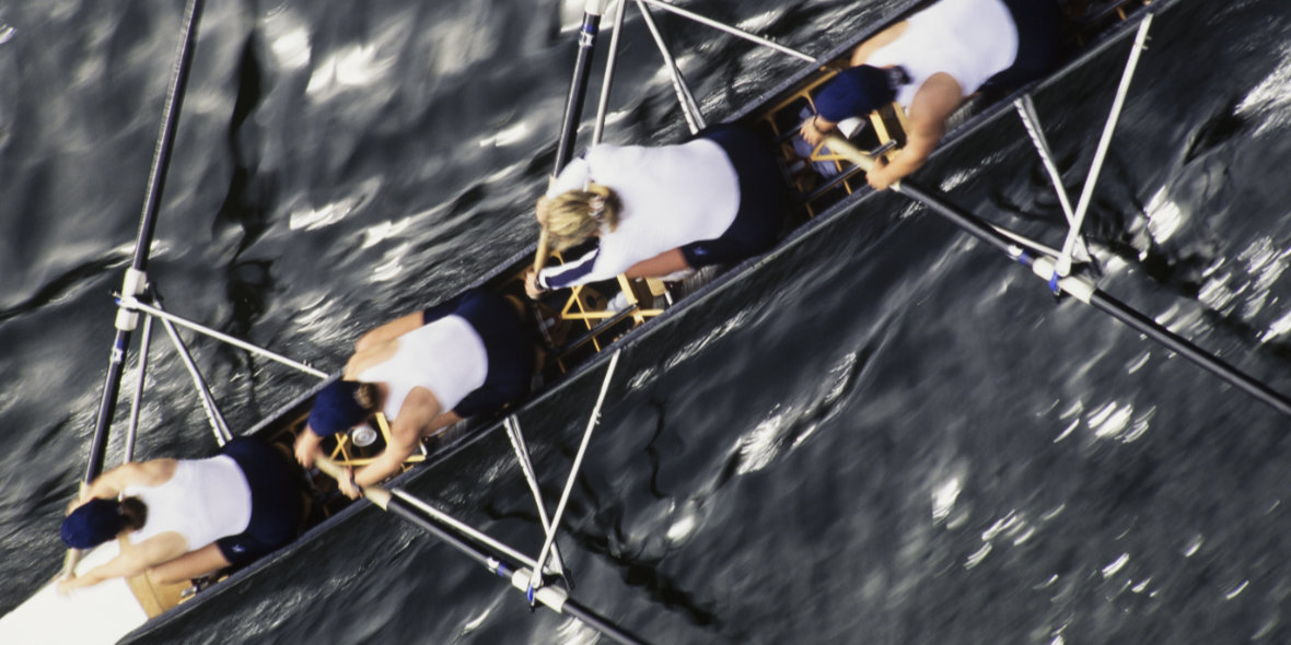 Overhead view of a female rowing crew in their racing shell, rowing boat.